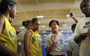 pic of girls b-ball team coach huddle
